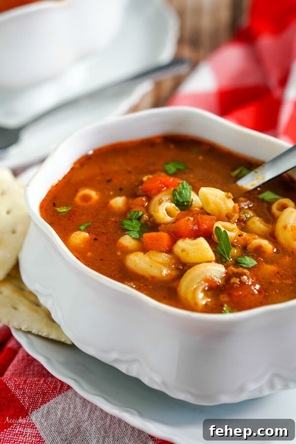 Garlic Bread Sloppy Joes: Cheesy, Savory Sloppy Joe Twist 4 A white soup tureen full of hamburger macaroni soup with a soup spoon in the bowl and crackers to the side.