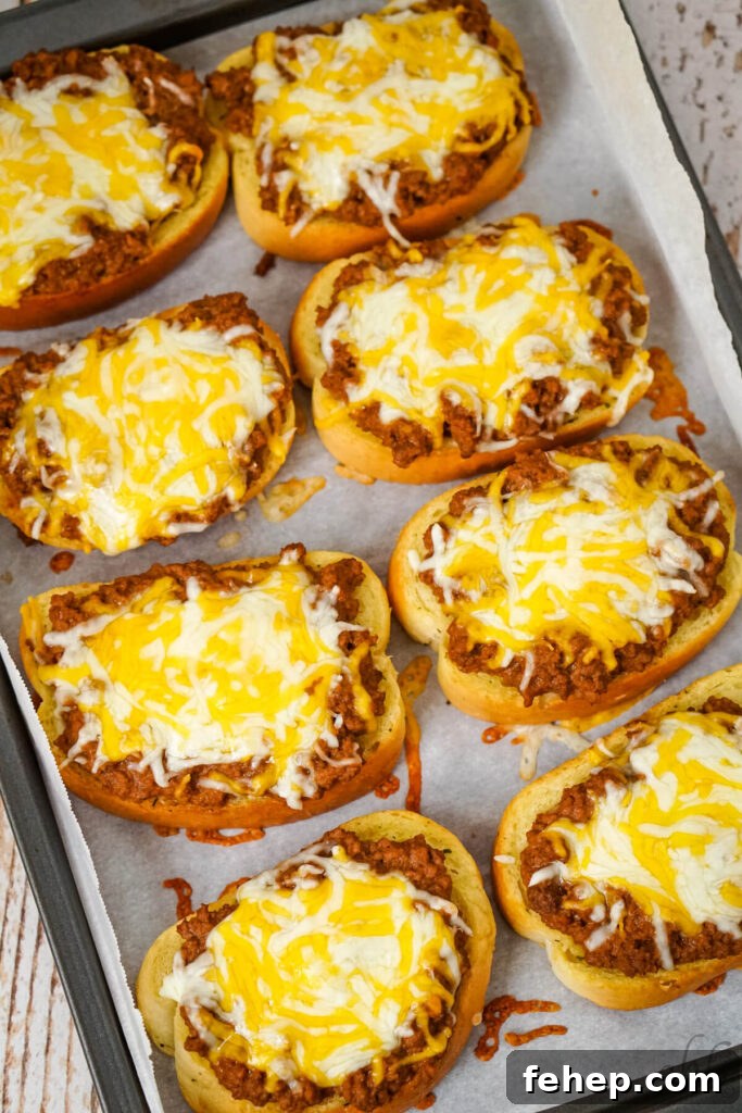 Garlic Bread Sloppy Joes: Cheesy, Savory Sloppy Joe Twist 9 A baking tray of finished Garlic Bread Sloppy Joes topped with melted colby jack cheese.