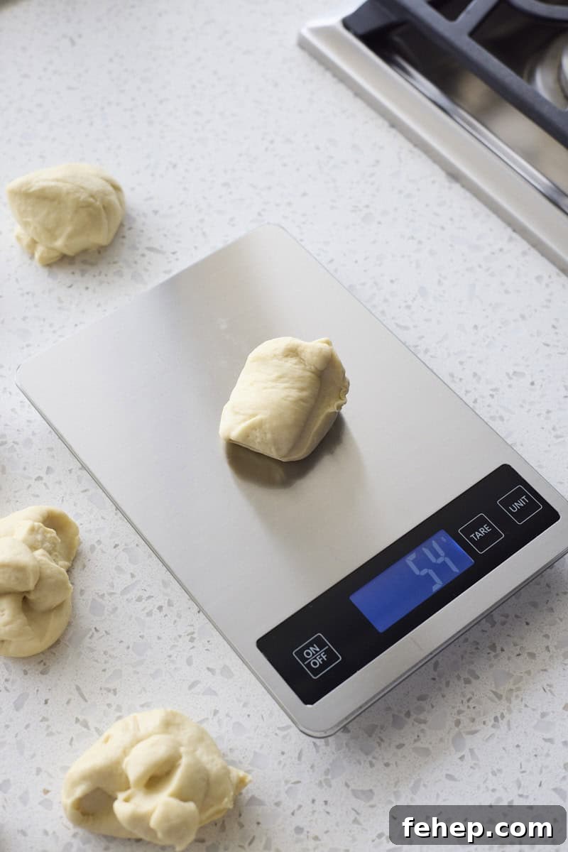 Dough being divided and weighed on a kitchen scale.