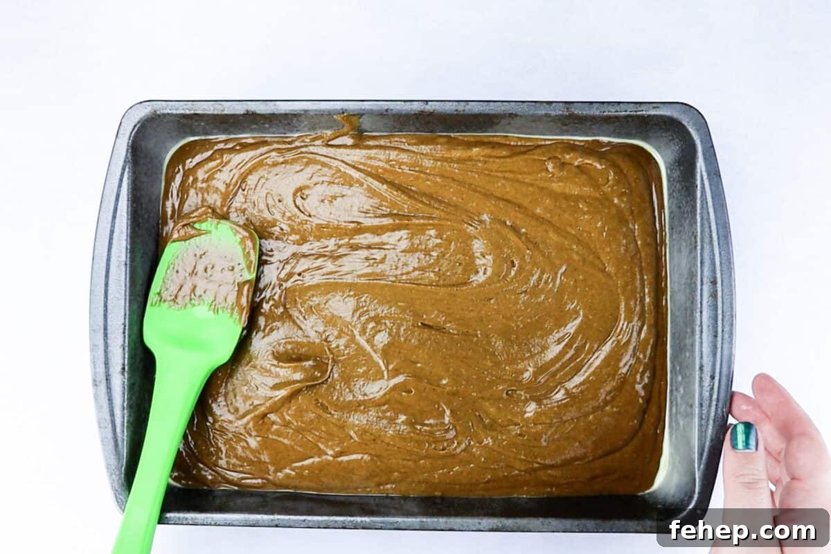 Gingerbread Trifle Recipe: Festive Layered Dessert for Holidays 10 gingerbread cake batter in pan before baking.