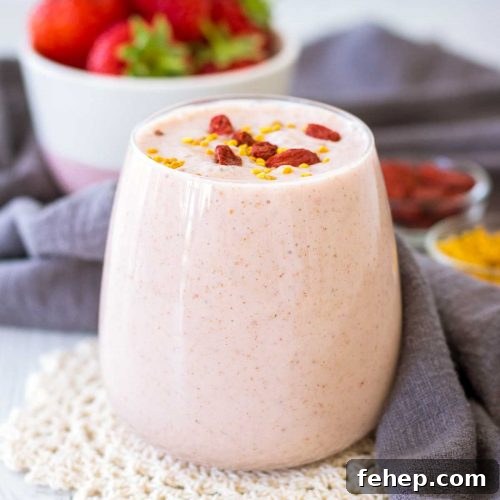 Strawberry Peanut Butter Smoothie served in a glass topped with goji berries