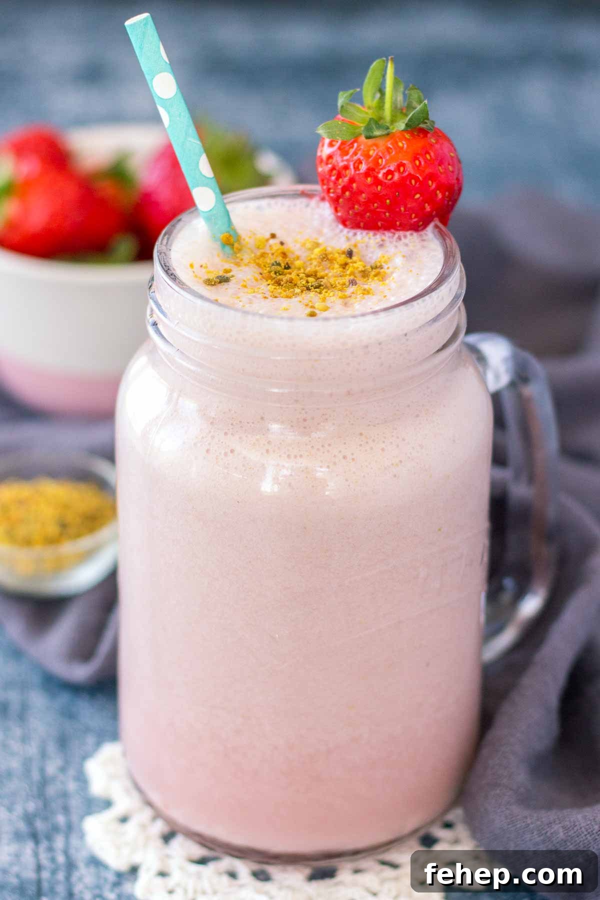 Homemade Strawberry Milk in a glass with a straw