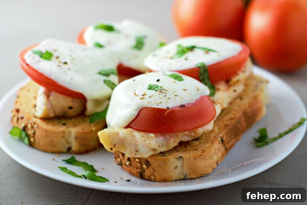 Open Face Chicken Caprese Sandwiches with tomato, mozzarella, and basil on a plate.