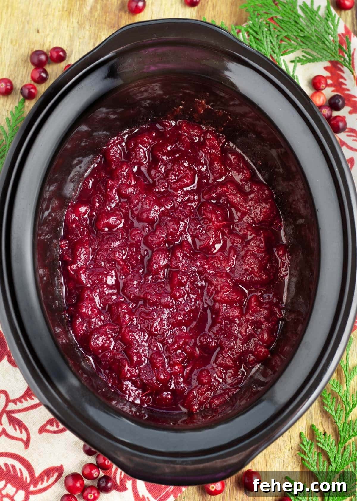 Slow Cooker Cranberry Sauce in a black crock