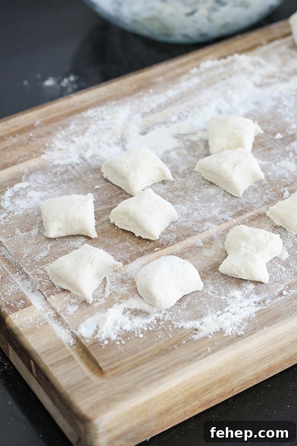 Cinnamon Sugar Pretzel Bites (Yeast-Free) 6 dough cut into bite-sized pieces on a wooden cutting board.