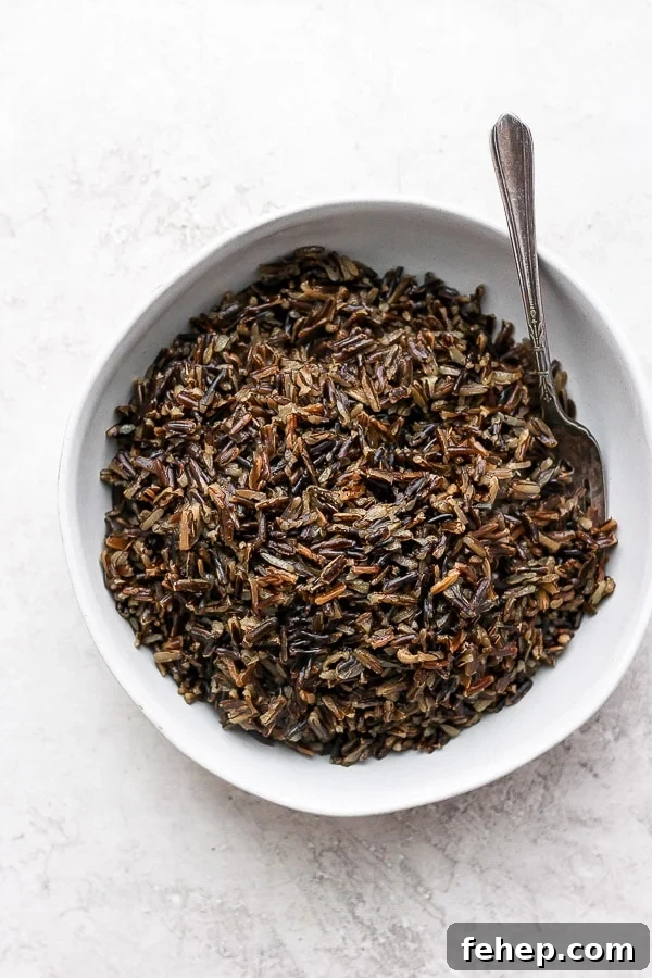 Instant Pot Wild Rice in a white bowl with a fork.