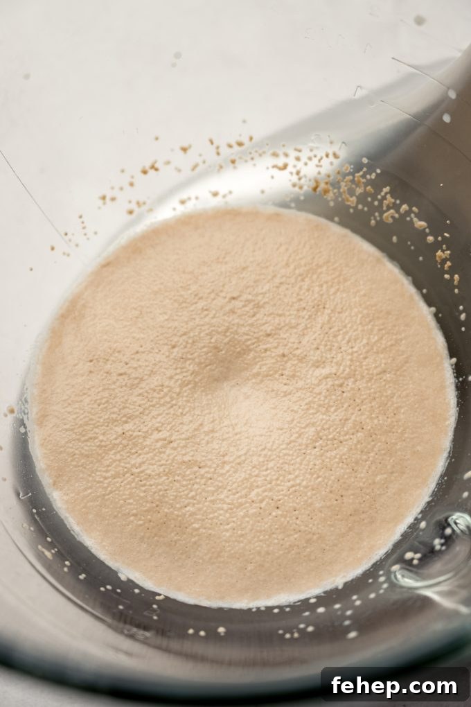 Yeast that has been activated in the bottom of a bowl of a stand mixer.