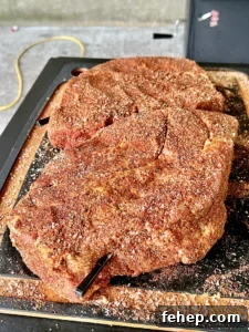 seasoned chuck roast on a cutting board