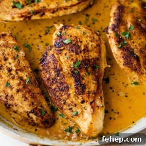 close-up of cajun chicken in a large skillet with chopped parsley on top