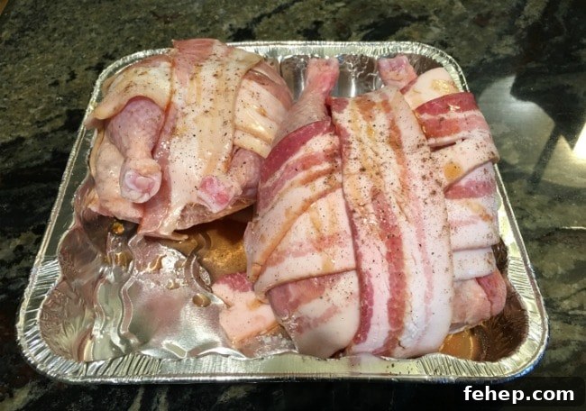 Bacon-Wrapped Cornish Hens with 3 Simple Ingredients 5 Cornish game hens wrapped in raw bacon, ready to bake.