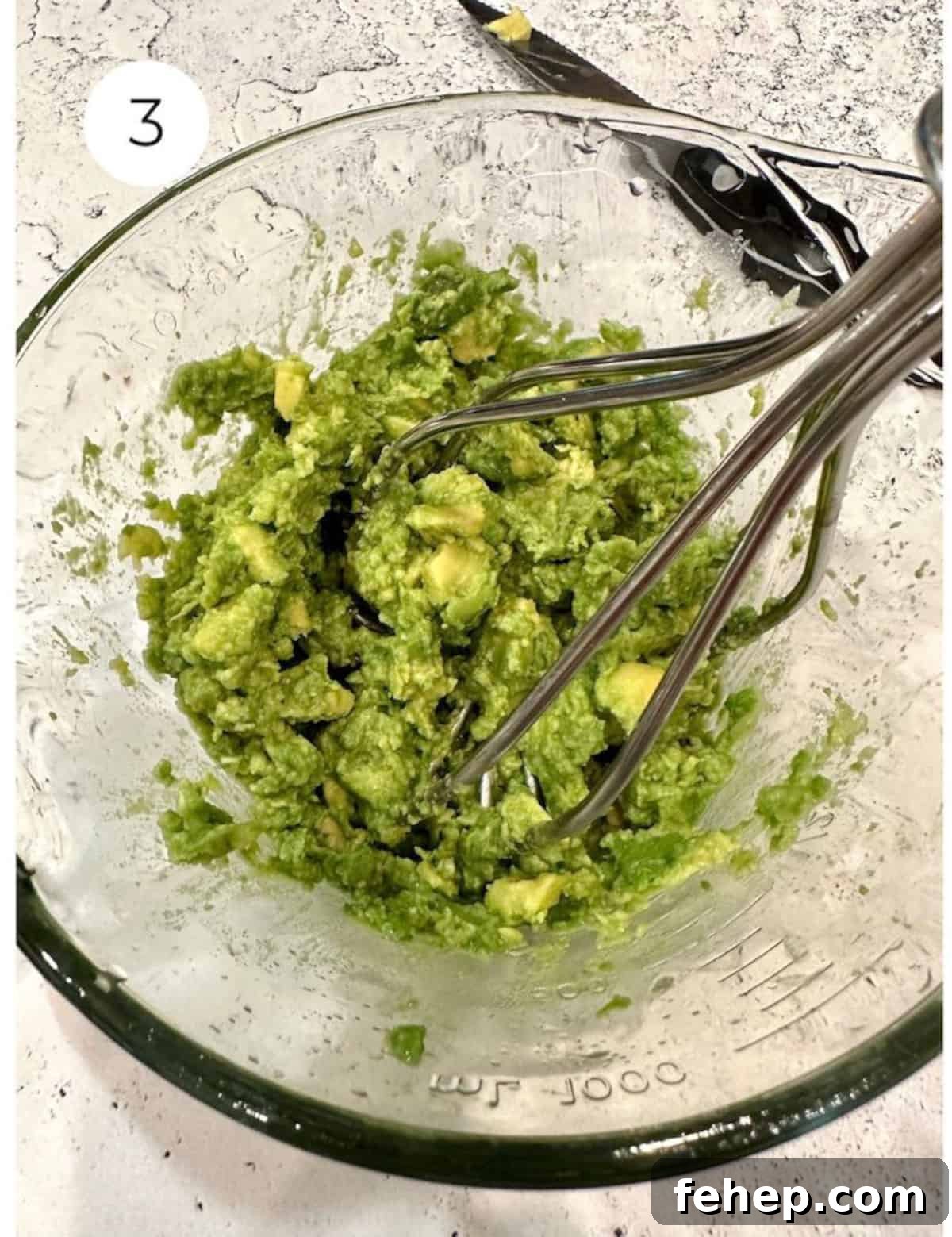 Mashed avocado in a bowl.