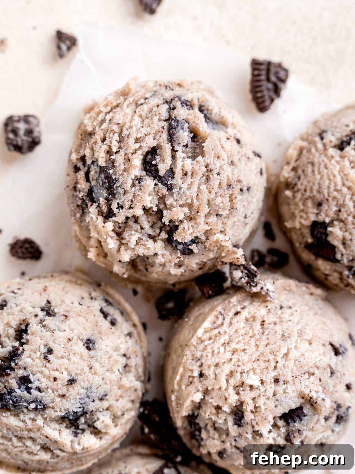 Edible Cookies and Cream Cookie Dough Recipe for Safe Snacking 2 Scoops of cookies and cream cookie dough surrounded by chopped Oreos.