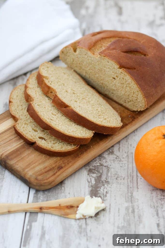 Modern Scandinavian Christmas Eve Smorgasbord Menu Ideas 14 Sliced limpa bread on top of a wooden cutting board next to an orange