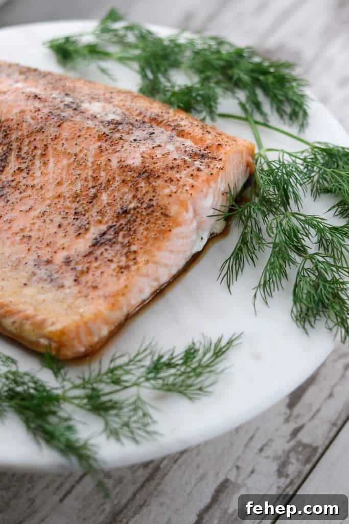 Modern Scandinavian Christmas Eve Smorgasbord Menu Ideas 5 A piece of salmon on a plate with fresh dill