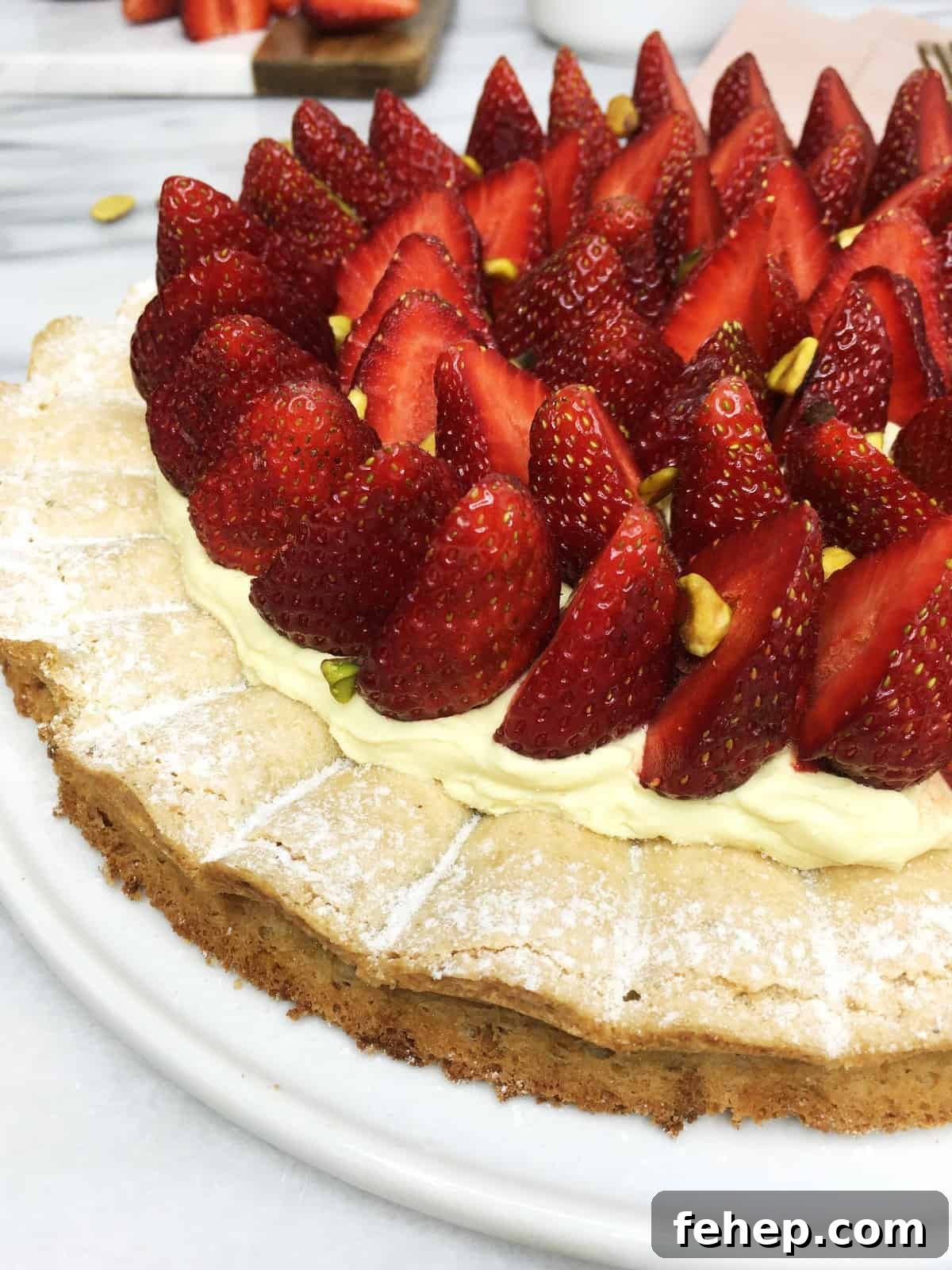 15 Irresistible Cake Recipes for Every Occasion 11 Recipe: Pistachio dacquoise cake topped with cream and strawberries on a white plate