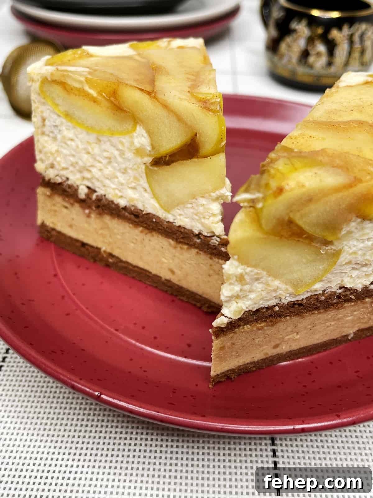 15 Irresistible Cake Recipes for Every Occasion 6 Two slices of apple mousse cake on a red dessert plate with teacups and saucers