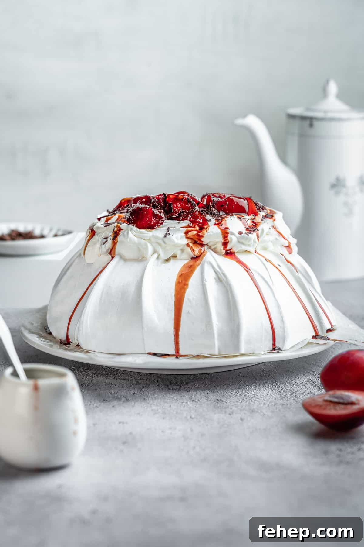15 Irresistible Cake Recipes for Every Occasion 9 Poached plum Pavlova on a serving plate.