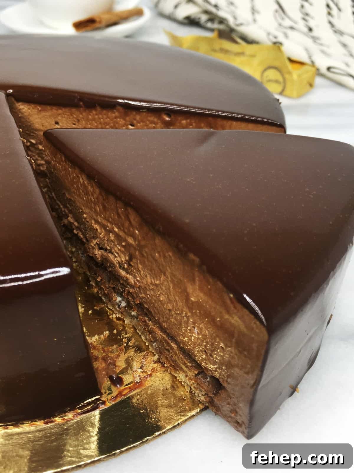 15 Irresistible Cake Recipes for Every Occasion 10 Sliced cake Trianon on a cake board with crepes Gravottes, a cup and a towel on background
