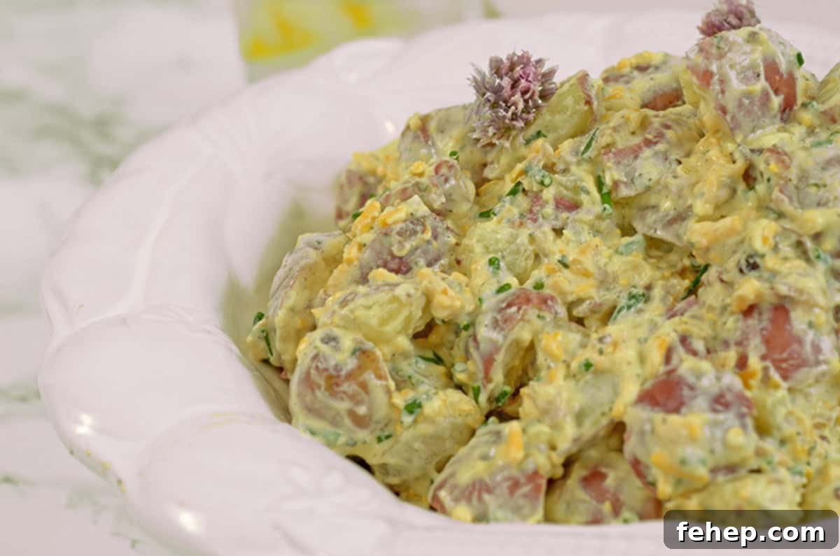 Creamy Bacon Ranch Potato Salad Recipe for Summer BBQs 5 Some potato salad in a white bowl.