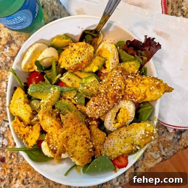 Creamy Bacon Ranch Potato Salad Recipe for Summer BBQs 10 Overhead view of a turmeric chicken salad in a white bowl.