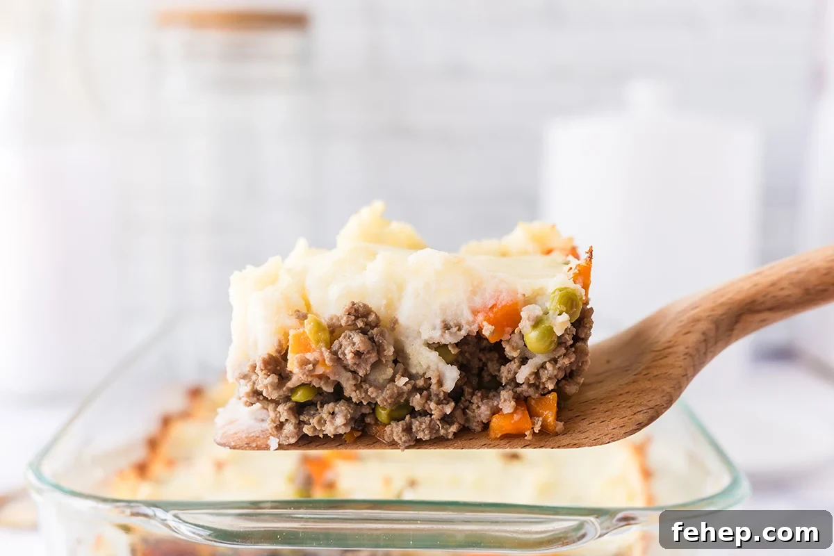 Serving of Shepherd's Pie on wooden spatula.