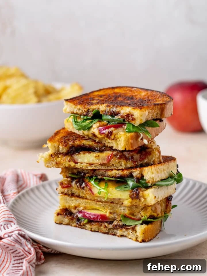 Gruyère Grilled Cheese with Fig Jam and Apple Slices 2 stack of grilled cheese sandwiches with apple, fig, bacon and arugula