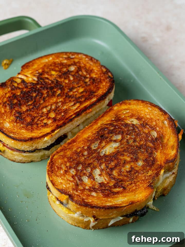 Gruyère Grilled Cheese with Fig Jam and Apple Slices 10 two grilled cheese sandwiches on a griddle