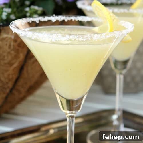 Two glasses of Lemon Drop Martini on a silver tray and with a sugar rim.