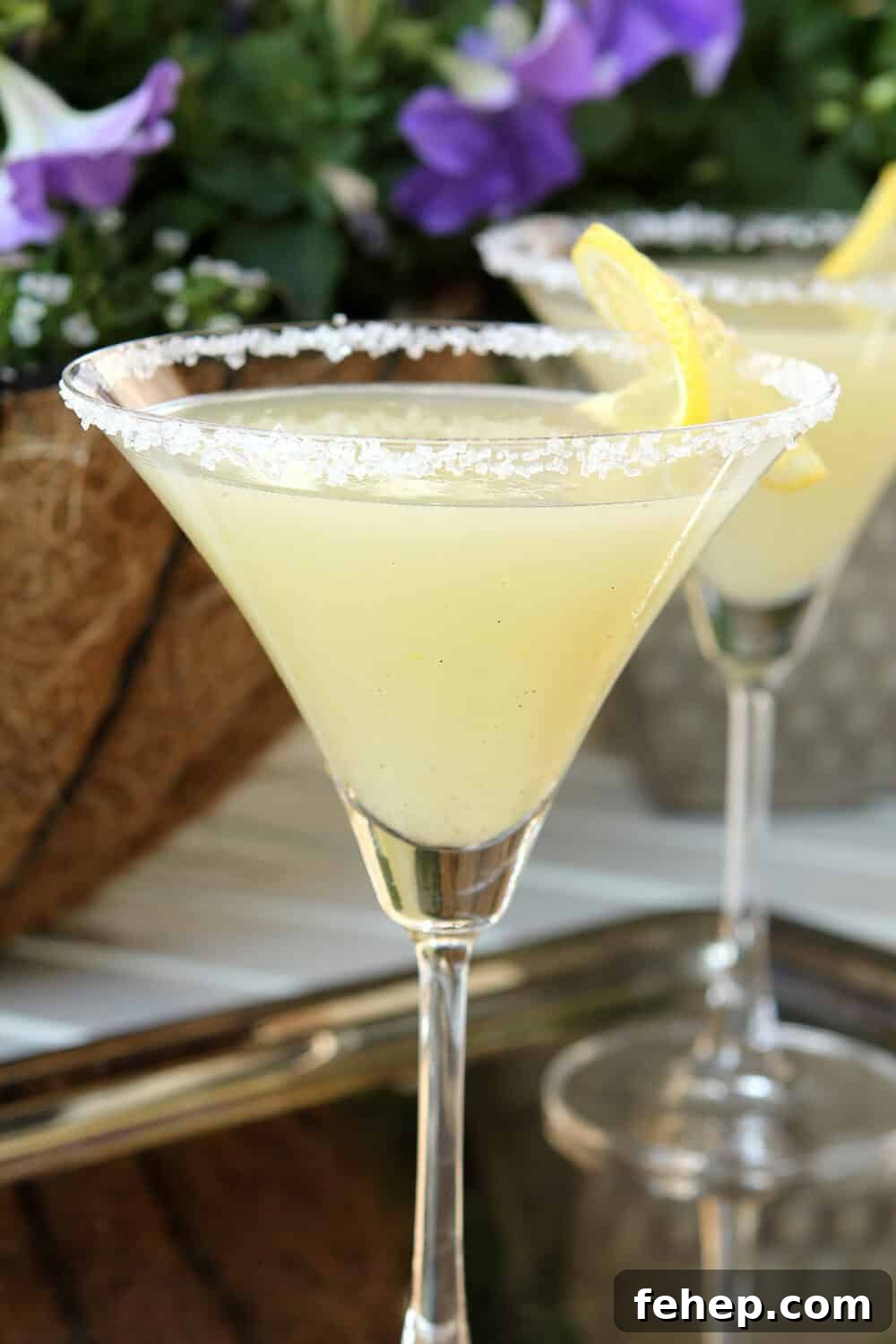 Lemon Drop Martini with Vanilla Bean Flecks garnished with a lemon slice and a sugared rim.
