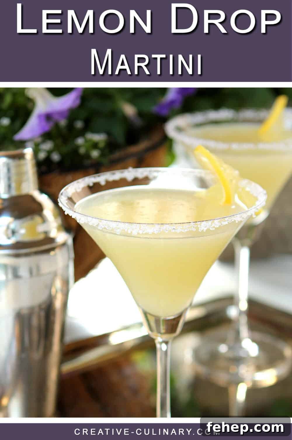 PIN for Lemon Drop Martini with Vanilla Bean Flecks garnished with a lemon slice and a sugared rim.
