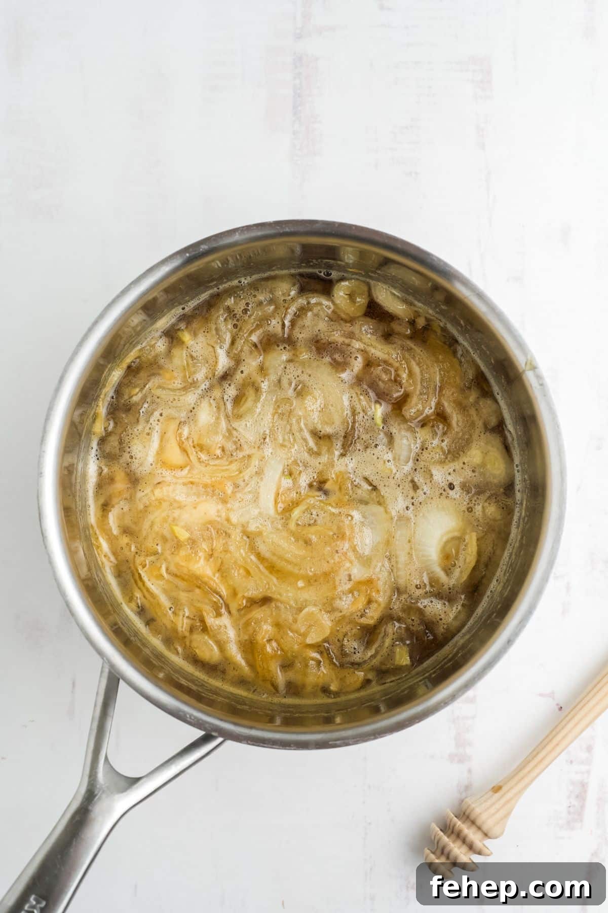 Homemade Honey and Onion Cough Syrup Recipe for Quick Relief 6 Onions and garlic cooked in honey in a saucepan.