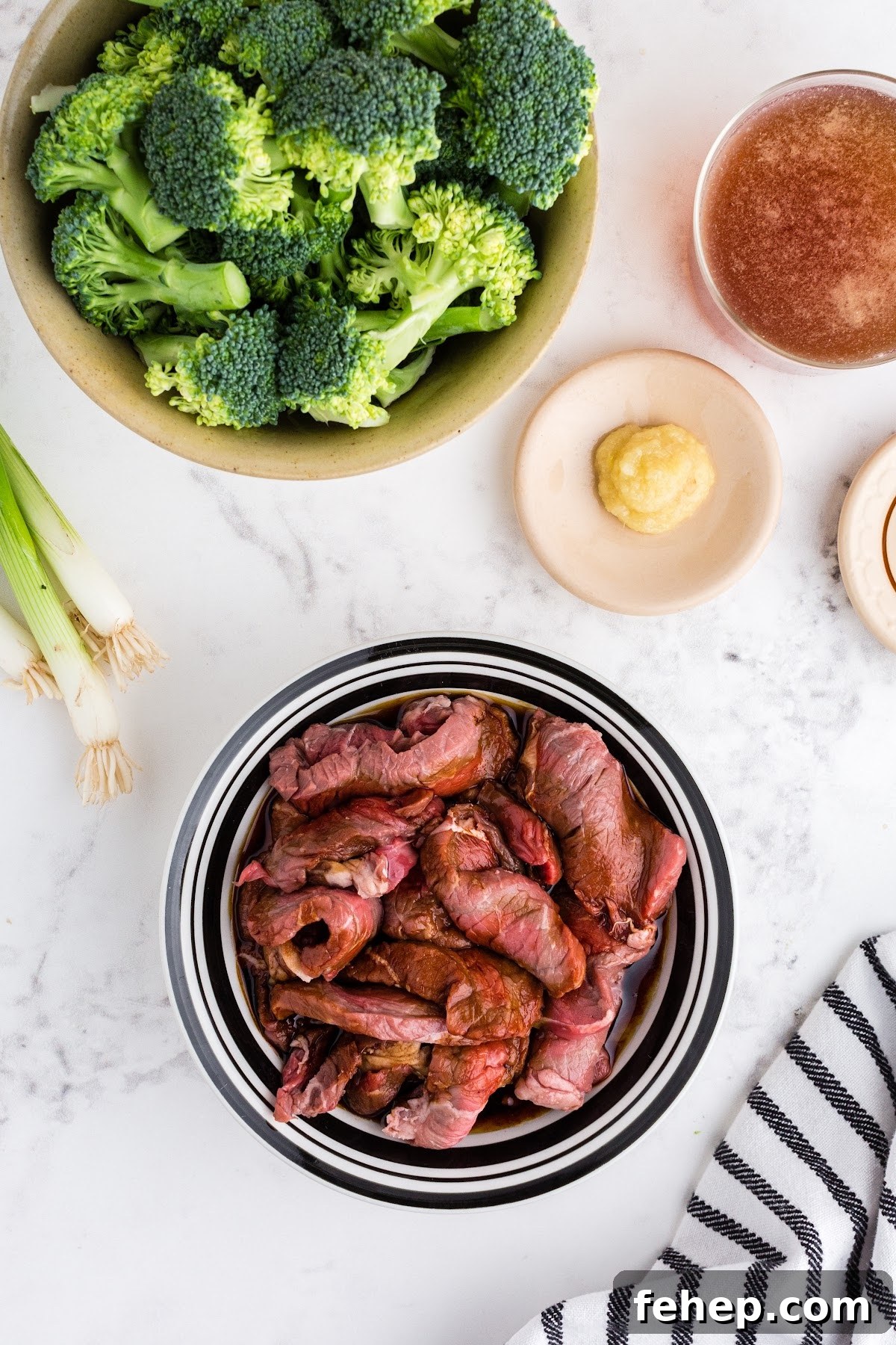 Panda Express Beef and Broccoli Recipe (Copycat Version) 4 Sliced beef in glass bowl with a soy marinade to prep the beef and broccoli recipe.