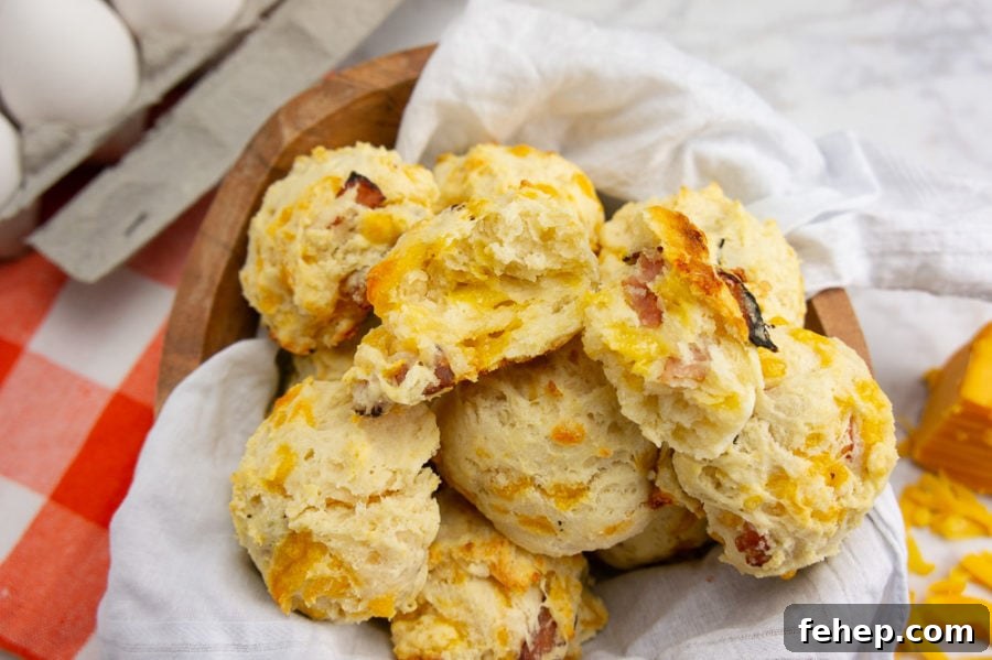 Savory Ham and Cheese Biscuit Recipe for Breakfast or Brunch 6 a bowl of ham and cheese biscuits with eggs on an orange checked napkin