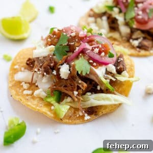 Sangrita: The Essential Mixer That Completes Tequila 9 Close up of carnitas taco on a white background.