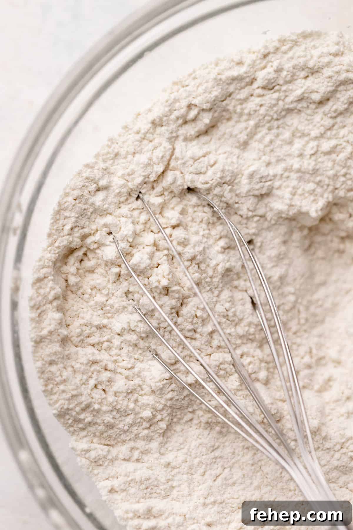 Dry ingredients being whisked in a bowl.