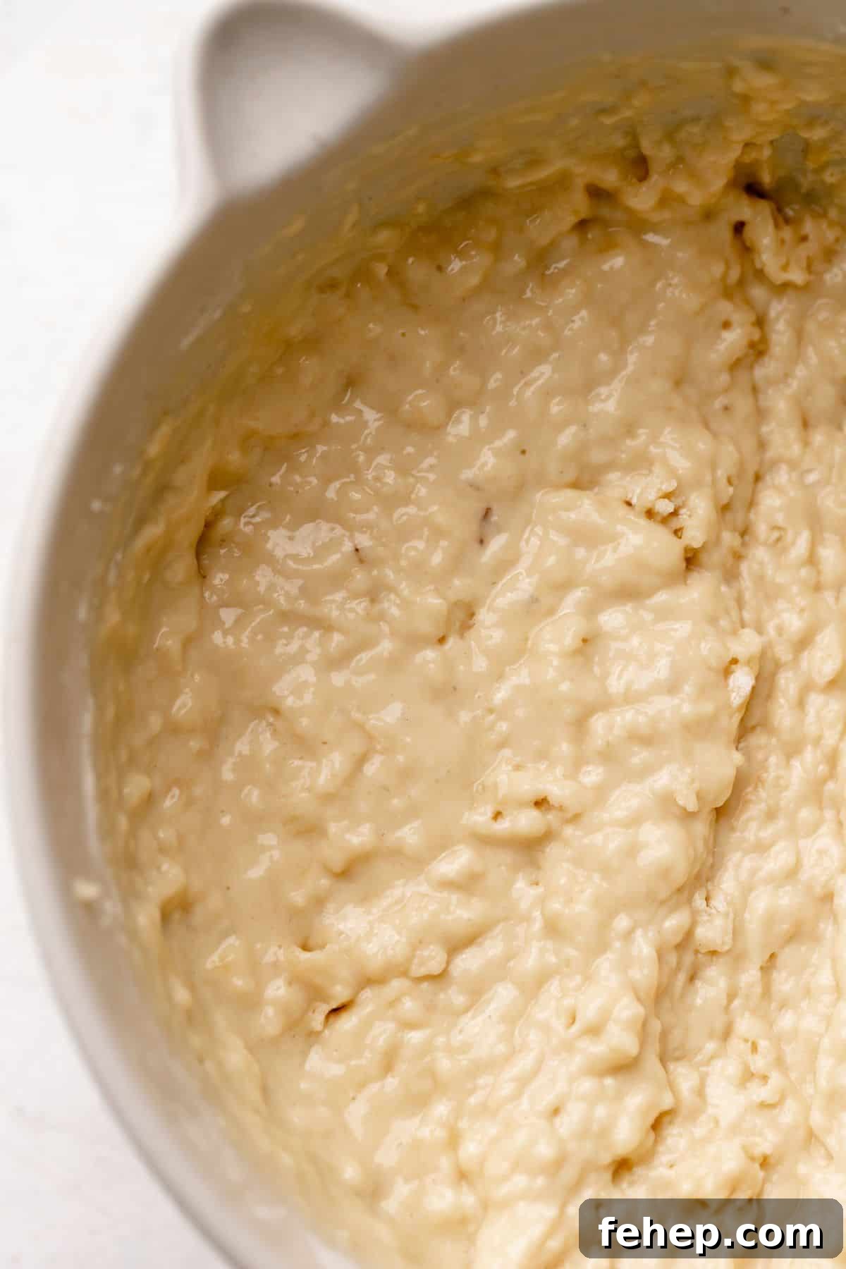Banana muffin batter in a mixing bowl.