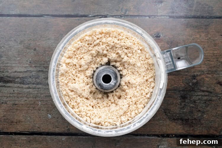 Vegan Empanadas: Flavorful Plant-Based Empanada Recipes 6 Overhead view of a food processor bowl of empanada dough ingredients.