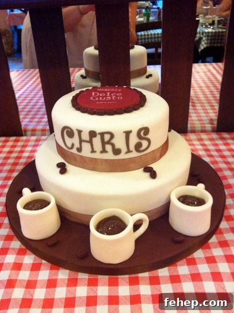 Two tier cake with sugar coffee cups and a Costa sugar logo
