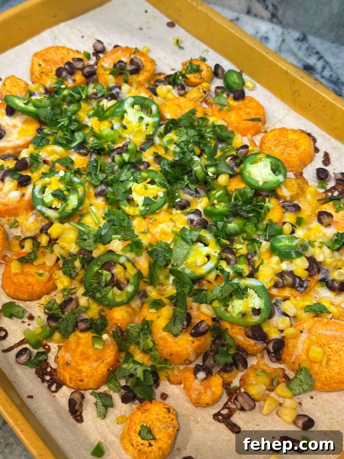 fully loaded sweet potato nachos on sheet pan