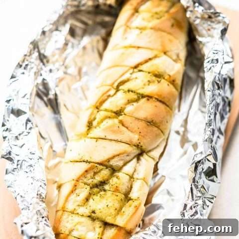 Try this quick and easy garlic bread that you can serve as a side dish or as a starter. Make with soft French baguette and pesto. Want to try visit fastfoodbistro.com for the full recipe #fastfoodbistro #garlicbread #breadrecipe #baguette #sidedish