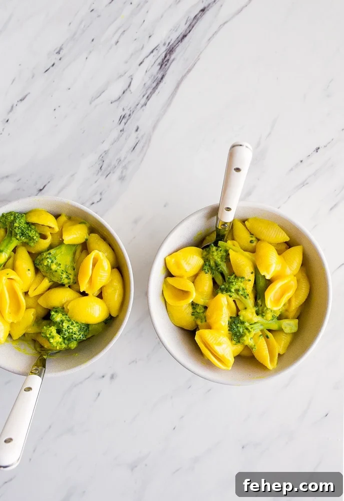 Healthy Mac and Cheese with turmeric, broccoli, and nutritional yeast. Perfect healthier version of macaroni and cheese for toddlers.