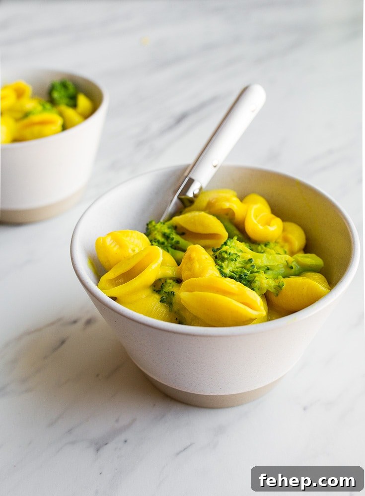 Healthy Mac and Cheese with turmeric, broccoli, and nutritional yeast. Perfect healthier version of macaroni and cheese for toddlers.