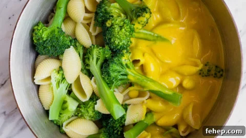 Healthy Mac and Cheese with turmeric, broccoli, and nutritional yeast. Perfect healthier version of macaroni and cheese for toddlers.