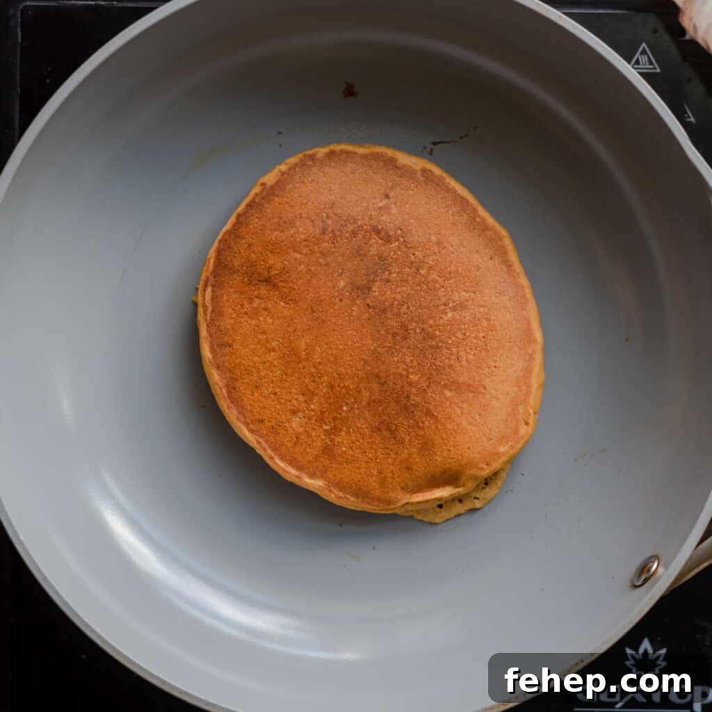 golden pancake cooking in skillet