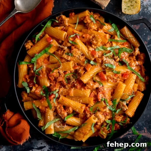 Overhead photo of a black frying pan full of spicy sausage rigatoni.