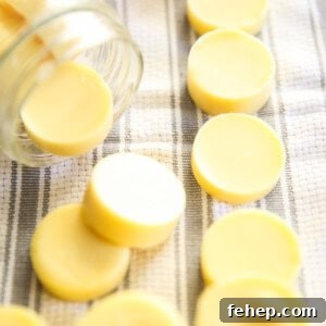 Homemade lotion bars on white and gray towel in a mason jar.