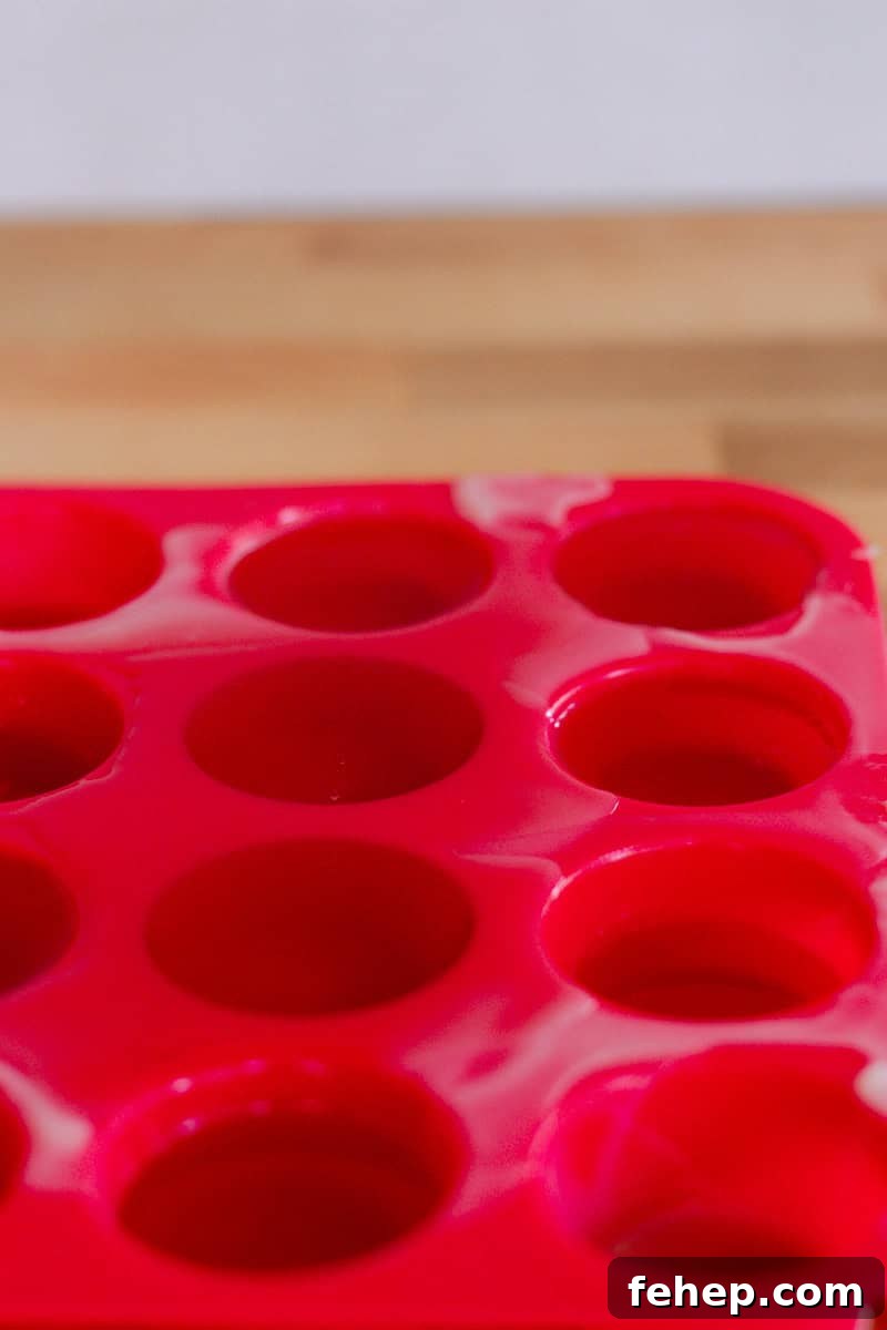 Silicone lotion bar molds with liquid lotion bar batter in them.