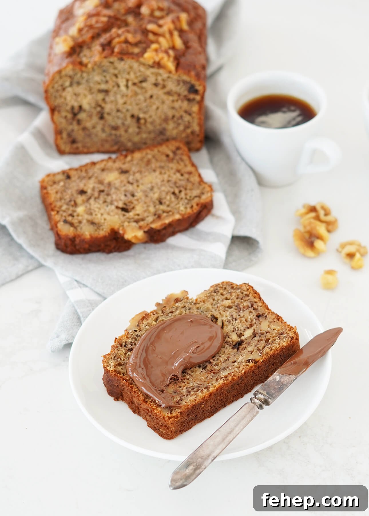 A slice of perfect banana bread slathered with hazelnut spread // FoodNouveau.com