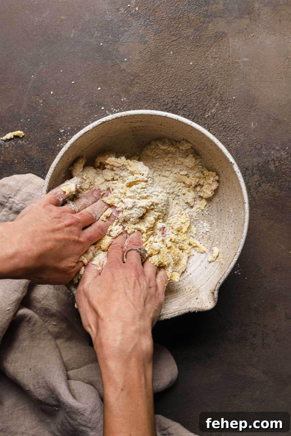 Italian Pasta Frolla Shortcrust Pastry: Multipurpose Dough Guide 11 Hand bringing dough together in a large bowl.