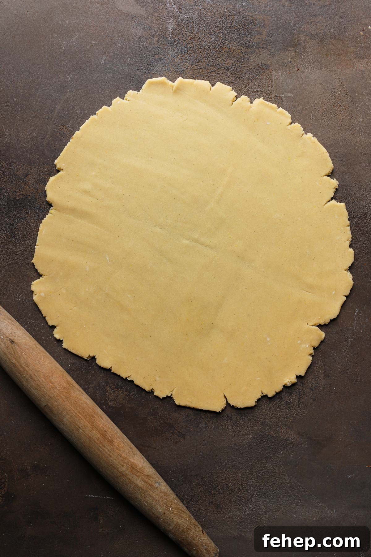 Italian Pasta Frolla Shortcrust Pastry: Multipurpose Dough Guide 13 Rolled dough next to a rolling pin.